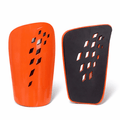 Ventilated football shin guards in orange and white